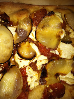 Tomato onion and goat cheese pizza - closeup