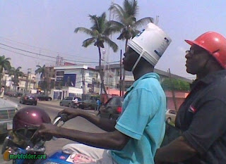 plastic bucket as helmet on motorcycle