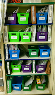 Different color plastic bins on shelves