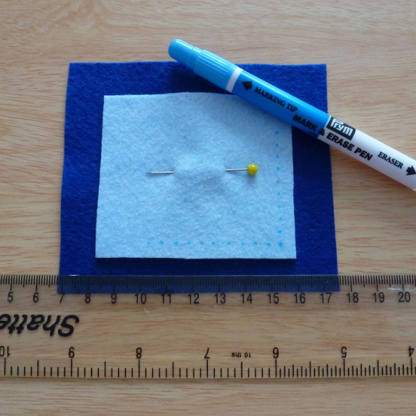 Ruler, pinned felt and erasable fabric pen marking fabric