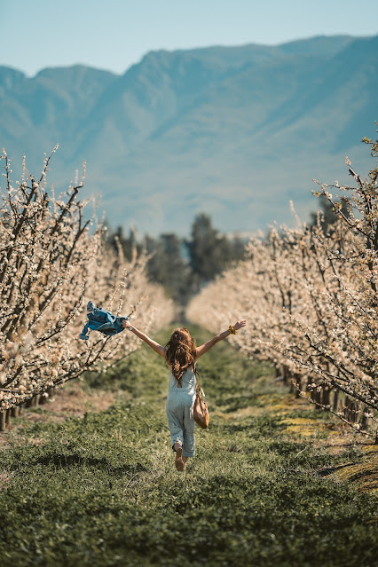 girl in field of flowers, image via Pexels