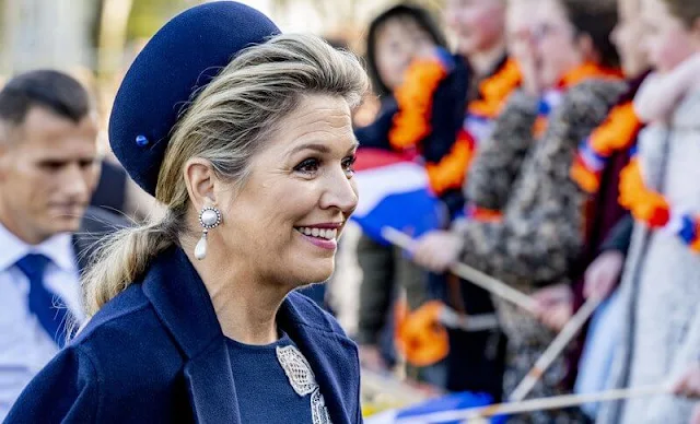 Queen Maxima wore a new stretch wool long sleeve embossed dress by Oscar de la Renta, and navy wool coat by Natan