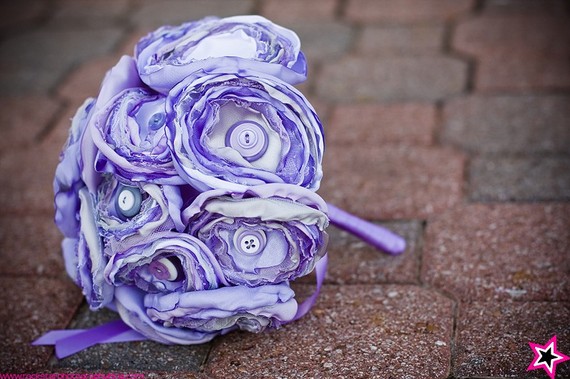 In several of their pictures she was holding a color fabric button bouquet 