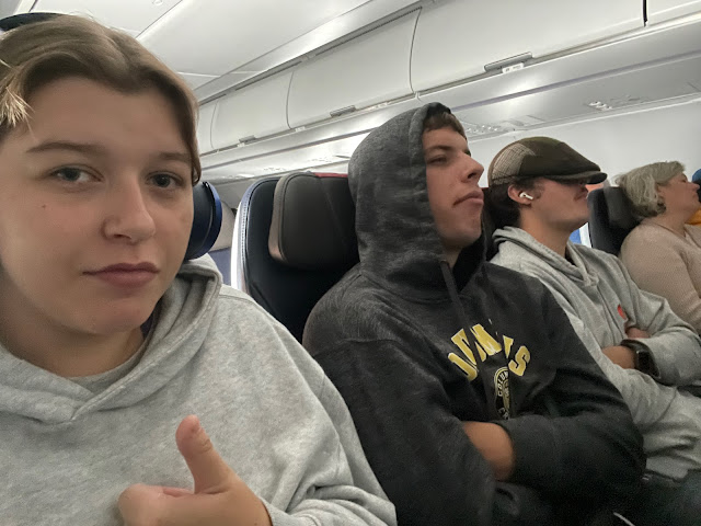 Elizabeth, Josh, and Andy sitting side by side on the plane taking us home.