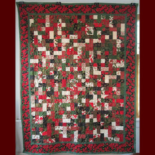 A Christmas-themed quilt with red border
