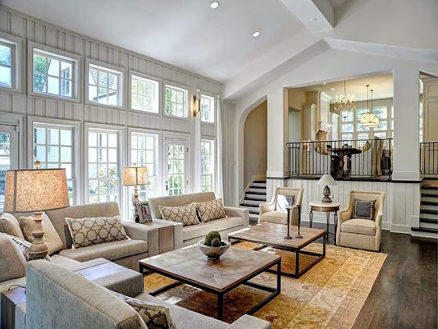 large open floor plan white living room traditional decor neutral colors two story windows