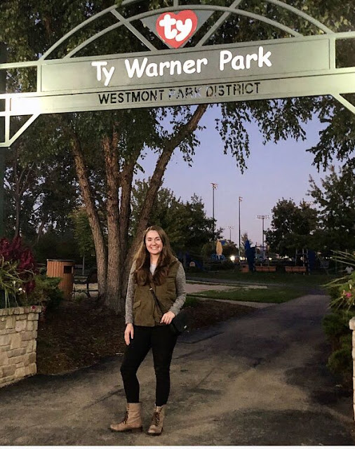 Model is wearing cargo jacket, combat boots, and black leather accessories.