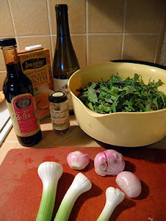 Bowl of Kale Strips, Condiments, and Green Garlic and Shallots on Cutting Board