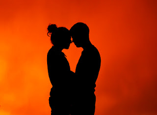 Imagen de un hombre y una mujer abrazados bajo la luz del sol