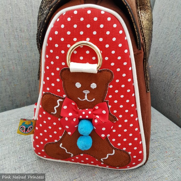 polka dot side of handbag with bitten gingerbread man applique