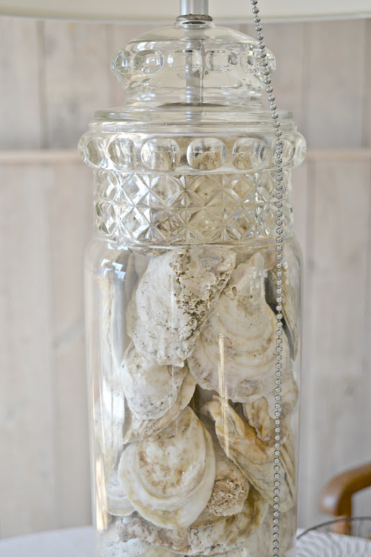 oyster shells in an old apothecary jar lamp title=