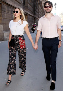 Robbie Arnett walking holding hand with his wife Elizabeth Olsen