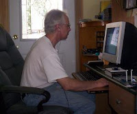 Rob listening to his music on the computer with his RockBuds