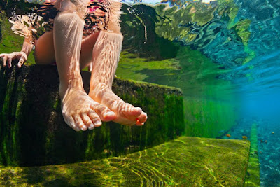 image of feet from under water, dangling ing mineral water