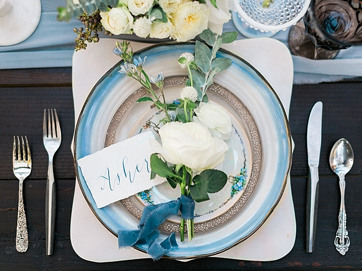 Elegant place settings on top of marble chargers with calligraphy name cards | Photo by Dennis Roy Coronel | See more on thesocalbride.com