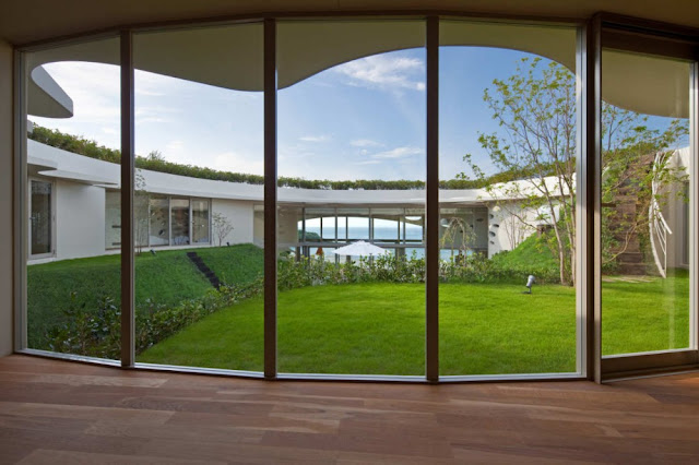 Photo of backyard in the middle of round home as seen from the house