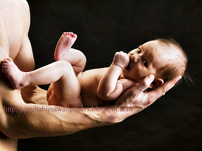 Newly born cute boy on his fathers hand wallpapers