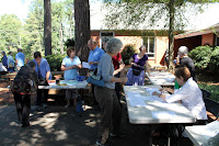 People chatting at information tables outside in the CUCC courtyard