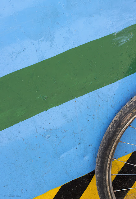 A Minimalist Photo of Bicycle Tyre and Colorful Lines