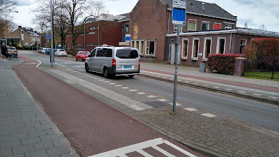 A view across the feature at an angle with a grey taxi passing through the middle.