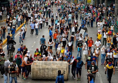 demonstrators roll a water pipe