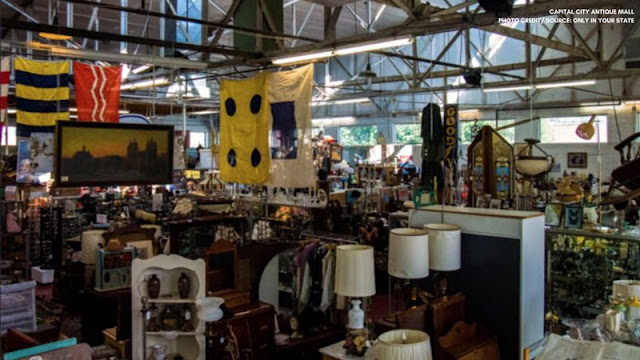 Antique store with lamps, flags, and paintings