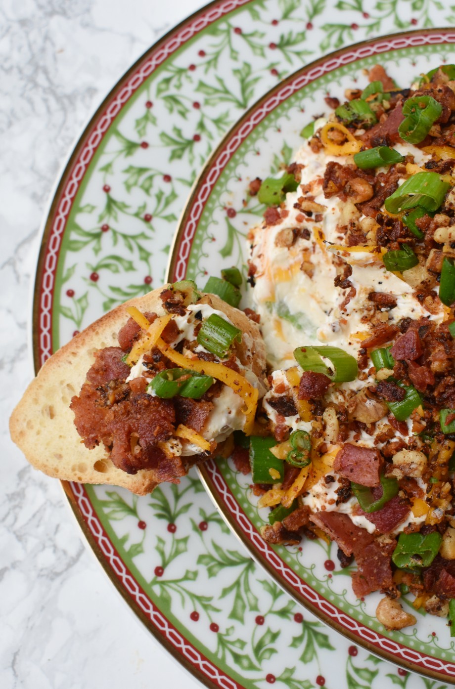 Bacon Walnut Cheese Ball features a cheese ball made with sharp cheddar cheese, fresh green onion, crispy bacon and bacon toasted walnuts. Served with garlic crostini for an indulgent, creamy and rich dip! #bacon #appetizer #cheeseball #cheese #holidays