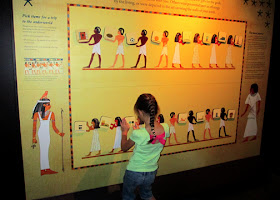 Tessa thought about what kind of things from today's world she would want to take with her to an Egyptian afterlife. Using a magnetic board and picture tiles designed after artwork commonly found on the walls of Egyptian tombs, she placed those items in the hands of servants who would bring them to her in the afterlife.