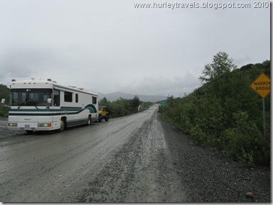 The beginning of the gravel road on Denali Highway, one lane bridge over Susitna River.  Ferd and Ole Yeller are showing their true colors.