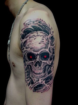 Flaming skull forearm tattoo.