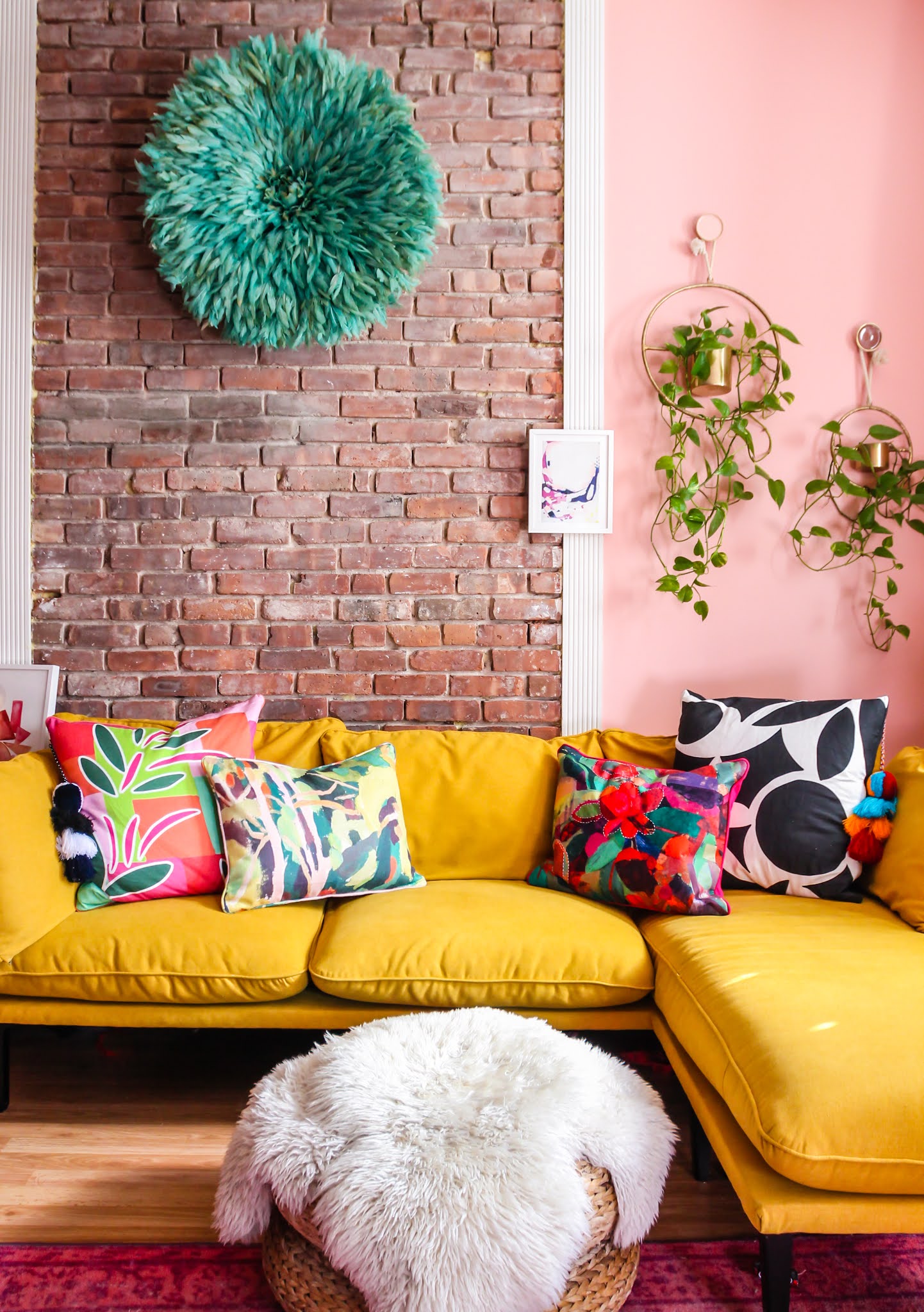 colorful throw pillows // missio throw pillow // Annie Selke throw pillows // opal house throw pillows // yellow sofa // bright throw pillows // exposed brick living room // pink living room // pink and yellow decor