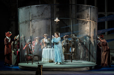 Julia Sporsén as Káťa and members of the OHP Chorus in Opera Holland Park’s production of Káťa Kabanová, directed by Olivia Fuchs © Robert Workman