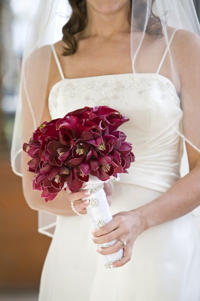 Burgundy calla lilies surrounded by red orchids Red bridesmaid bouquets 