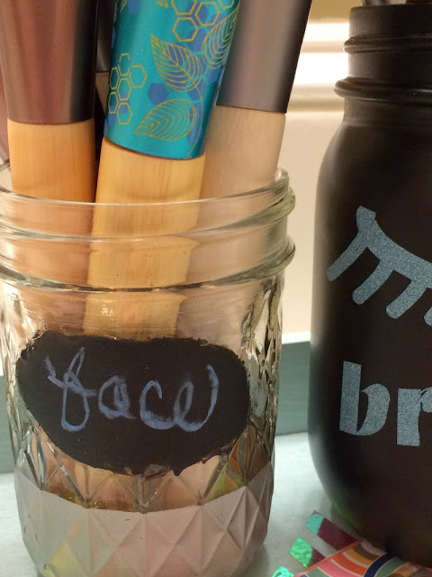 I used chalkboard paint and glitter vinyl to re-purpose mason jars into decorative holders for my makeup brushes.