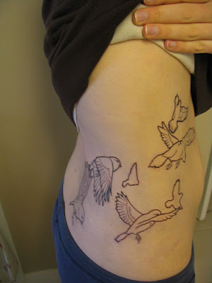 girls side tattoos with swallow tattoos