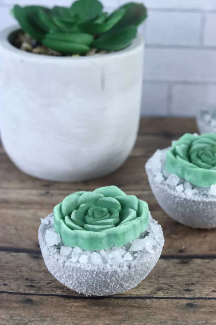 How to make cute DIY succulent bath bombs. These fake succulents would make a unique gift idea. This homemade bath bomb recipe is made with Epsom salt, baking soda, and essential oil and without cornstarch. It is full of fizzy bubbles when it hits the water.  Get ideas for home made bath bombs with a pretty succulent bath melt on top. I used the best bath bomb molds that are sturdy.  It's a plain circle mold, so there's no special one needed. #bathbomb #diy #succulent