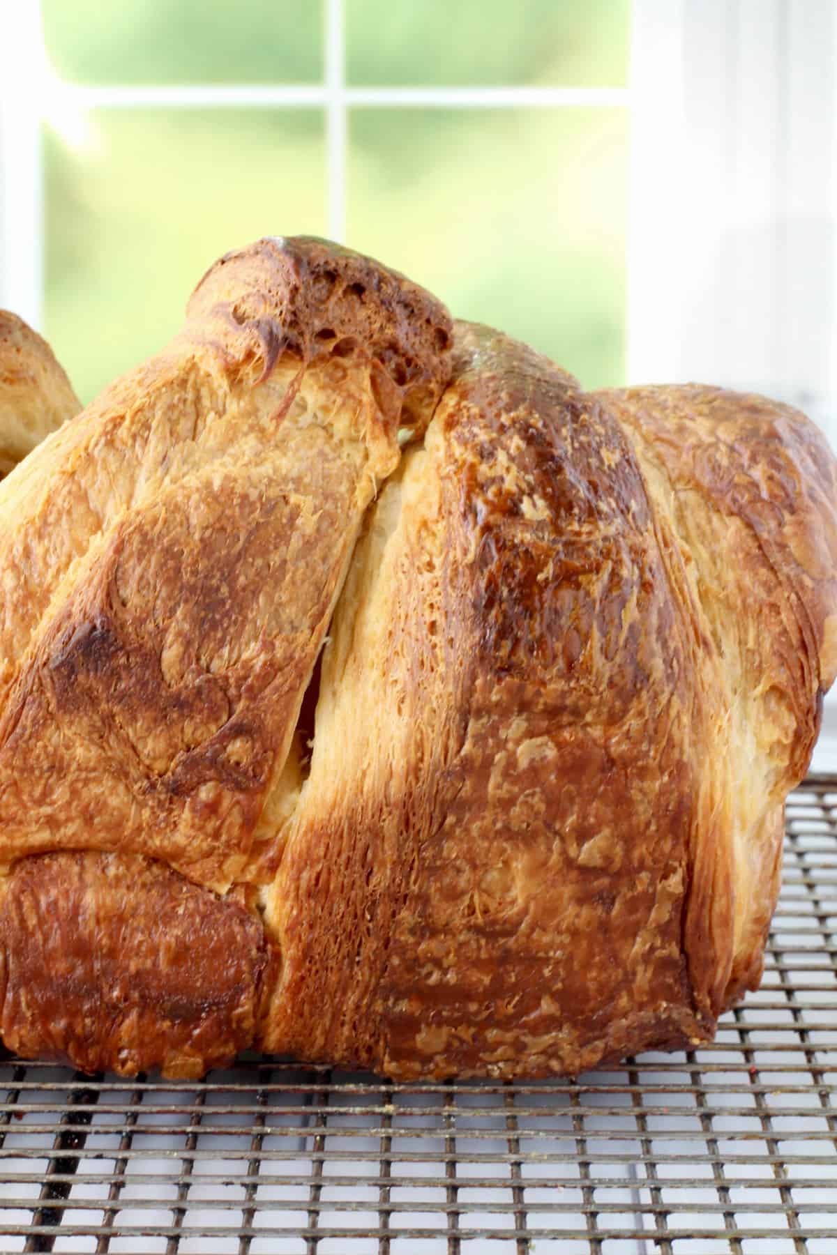 Croissant Bread loaf on a cooling rack.