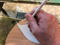 Tracing the template onto a piece of plywood