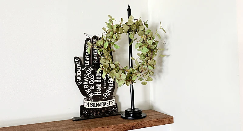 wreath stand and garden hand sign on mantel