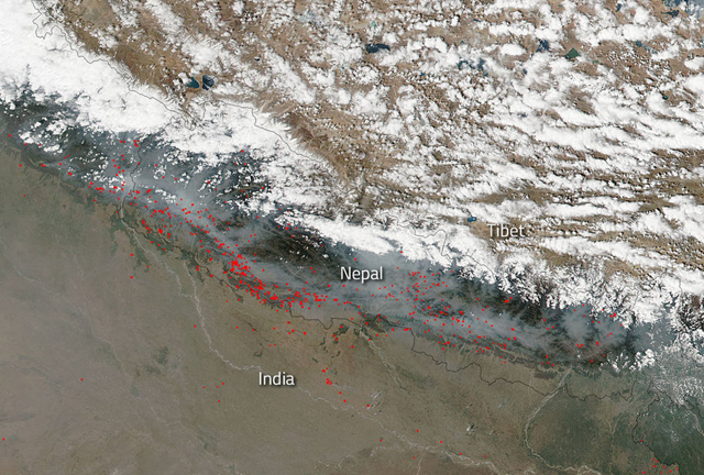 Satellite view of smoke and fires in Nepal, 11 April 2016. As many as 1.3 million hectares (over 3.7 million acres) of forest cover in Nepal was destroyed by wild fires in the previous two weeks. Photo: NASA