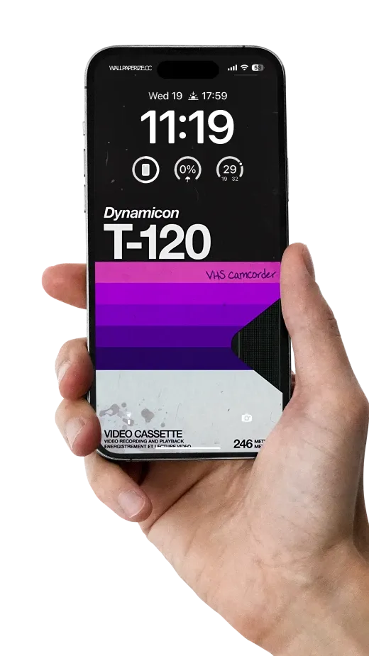 Stylish iPhone wallpaper with a vintage Dynamic VHS T-120 video cassette design, featuring purple and black color scheme.