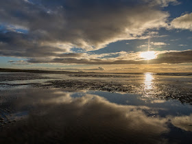 Photo of reflections in the wet sand on Maryport beach