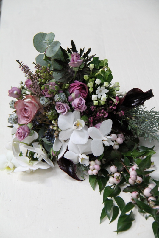 In this delightful cascading wedding bouquet we used Aubergine Calla Lilies