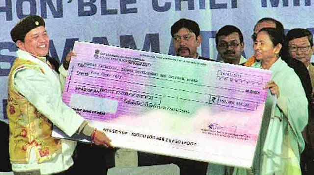 one of the Board chiefs receiving cheque from Mamata
