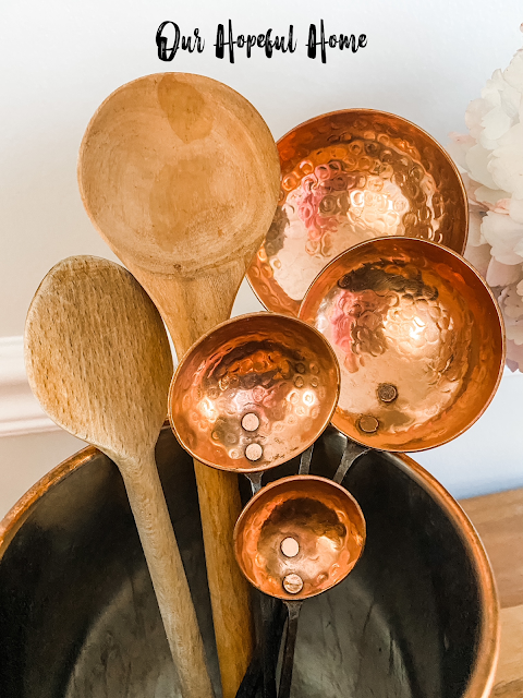 shiny copper ladle spoons wooden spoons