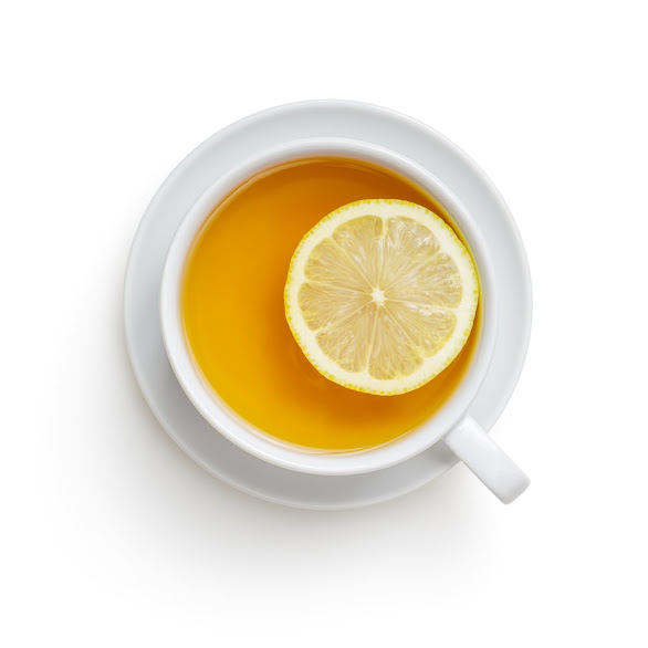 A cup of green tea with lemon