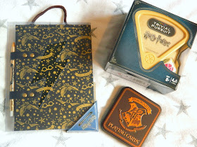 A Harry Potter notebook and pen set, Harry Potter trivial pursuit game, Harry Potter playing cards in a themed tin,