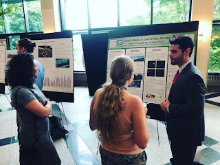Andrew Polich presenting his poster to a fellow participant (center) and Chelsea Loftus (left) at the 2019 Appalachian State Energy Summit.