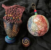 a collection of gourd art projects displayed on fabric
