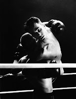 two men dancing in a boxing ring